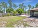 Expansive backyard with a pergola, ideal for outdoor activities and entertaining at 23227 Adela Ave, Port Charlotte, FL 33952