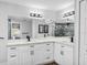 Modern bathroom featuring double sinks, elegant fixtures, ample counter space, and a decorative mirror at 23227 Adela Ave, Port Charlotte, FL 33952