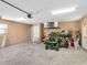Large, well-lit garage with epoxy floors, offering plenty of space for storage and projects at 23227 Adela Ave, Port Charlotte, FL 33952