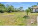 Grassy homesite for sale close to neighborhood homes at 23227 Adela Ave, Port Charlotte, FL 33952