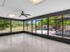 Screened-in patio providing a relaxing outdoor living space with views of the lush backyard and pergola at 23227 Adela Ave, Port Charlotte, FL 33952