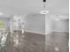 Bright and airy living room with glossy floors, neutral walls, and modern lighting, perfect for entertaining at 23227 Adela Ave, Port Charlotte, FL 33952
