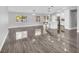 Bright living room featuring glossy floors, neutral paint, and modern lighting, creating an inviting open-concept design at 23227 Adela Ave, Port Charlotte, FL 33952