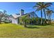 The house has a gorgeous screened-in porch and backyard with several palm trees, and plenty of green space at 24344 Penhollow Ct, Punta Gorda, FL 33955