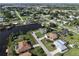 Overhead shot of a community boasting tree-lined streets and homes near waterways and canals at 3000 Wisteria Pl, Punta Gorda, FL 33950