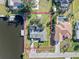 Aerial view of a single-Gathering home with a private boat dock and lush green lawn at 3000 Wisteria Pl, Punta Gorda, FL 33950