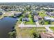 An aerial view of a charming neighborhood with waterfront access and well-maintained lawns at 3000 Wisteria Pl, Punta Gorda, FL 33950