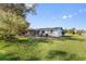 Wide backyard features a well-maintained lawn, patio, and pond views at 3000 Wisteria Pl, Punta Gorda, FL 33950