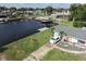 Waterfront home featuring a dock, well-manicured lawn, and driveway with parking at 3000 Wisteria Pl, Punta Gorda, FL 33950