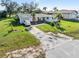 Charming single-story home with an attached garage and well-maintained lawn at 3000 Wisteria Pl, Punta Gorda, FL 33950