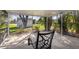 Enclosed back patio featuring a simple chair and screened walls for outdoor relaxation at 3000 Wisteria Pl, Punta Gorda, FL 33950