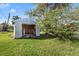 Exterior shot of a detached shed surrounded by lush greenery, providing extra outdoor storage space at 3000 Wisteria Pl, Punta Gorda, FL 33950