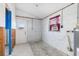 Utility room with cement block walls, equipped with an air conditioner and water heater at 3000 Wisteria Pl, Punta Gorda, FL 33950