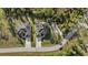 A well-placed home with a gravel drive, set next to a green lawn and community road for easy access at 3049 Seth Rd, North Port, FL 34288
