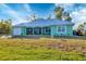 Charming single-story home featuring a durable metal roof, spacious front yard, and a convenient attached garage at 9158 Snapper Cir, Port Charlotte, FL 33981
