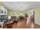 Spacious living room with hardwood floors, a ceiling fan, and comfortable seating for entertaining guests at 9158 Snapper Cir, Port Charlotte, FL 33981