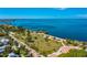 An aerial view of a waterfront park with palm trees, green spaces, and a pier at 1340 San Cristobal Ave # 305, Punta Gorda, FL 33983