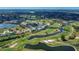 Aerial view of the community showcasing golf course, water features, and residential buildings at 1340 San Cristobal Ave # 305, Punta Gorda, FL 33983