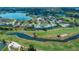 Aerial view of condo community situated on golf course with lakes, ponds, and mature trees at 1340 San Cristobal Ave # 305, Punta Gorda, FL 33983
