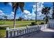 Beautiful backyard view with a green lawn, palms, and a white fence at 1340 San Cristobal Ave # 305, Punta Gorda, FL 33983