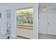 Charming wet bar with glass shelving, mirrored backsplash, and ample cabinet space for storage and entertaining at 1340 San Cristobal Ave # 305, Punta Gorda, FL 33983
