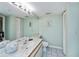 Bright bathroom with a long vanity, tiled floor, and a large mirror at 1340 San Cristobal Ave # 305, Punta Gorda, FL 33983
