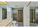 Updated bathroom with a glass-enclosed shower, marble countertop, and modern fixtures for a fresh look at 1340 San Cristobal Ave # 305, Punta Gorda, FL 33983