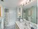 Well-lit bathroom with a vanity, large mirror, shower/tub, and neutral decor at 1340 San Cristobal Ave # 305, Punta Gorda, FL 33983