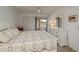 This bright bedroom features carpeted floors, white trim, ceiling fan, and slider access to the lanai at 1340 San Cristobal Ave # 305, Punta Gorda, FL 33983