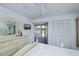 Comfortable bedroom with golf course views and access to screened lanai, combining relaxation and natural beauty at 1340 San Cristobal Ave # 305, Punta Gorda, FL 33983
