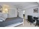 Neutral-toned bedroom with ceiling fan, closet, adjacent bathroom, and workstation for convenience at 1340 San Cristobal Ave # 305, Punta Gorda, FL 33983