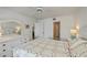 Bright bedroom boasts neutral carpet, white trim, ceiling fan, and access to the Primary bathroom at 1340 San Cristobal Ave # 305, Punta Gorda, FL 33983