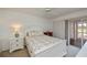 Cozy bedroom with slider access to a lanai, a ceiling fan, and bright neutral paint at 1340 San Cristobal Ave # 305, Punta Gorda, FL 33983