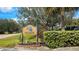 A sign for Deep Creek Golf Club with lush landscaping at 1340 San Cristobal Ave # 305, Punta Gorda, FL 33983
