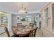 Cozy dining area with a marble-topped table, chandelier lighting, and access to the kitchen and living spaces at 1340 San Cristobal Ave # 305, Punta Gorda, FL 33983