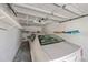 Spacious single-car garage with overhead door, shelving, and a car parked inside at 1340 San Cristobal Ave # 305, Punta Gorda, FL 33983