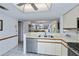 Open kitchen with white countertops, modern appliances, and view into living area at 1340 San Cristobal Ave # 305, Punta Gorda, FL 33983