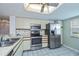 Bright kitchen featuring stainless steel appliances, tiled flooring, and neutral cabinetry at 1340 San Cristobal Ave # 305, Punta Gorda, FL 33983