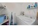 Well-equipped laundry room with washer, dryer, storage shelves and cleaning supplies at 1340 San Cristobal Ave # 305, Punta Gorda, FL 33983