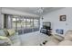 Comfortable living room with a screened lanai and golf course views, perfect for relaxing and entertaining at 1340 San Cristobal Ave # 305, Punta Gorda, FL 33983