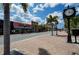 A view of River City Grill on a street with red brick, palm trees, and blue skies at 1340 San Cristobal Ave # 305, Punta Gorda, FL 33983