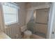 Bathroom featuring shower, toilet, and window with great natural light at 1345 Cambridge Dr, Venice, FL 34293