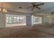 Spacious living room connecting to a lanai and featuring a mirrored wall, creating an open and airy feel at 1345 Cambridge Dr, Venice, FL 34293