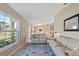 Bright living room featuring neutral decor, a patterned rug, and large window offering ample natural light at 1391 Abalom St, Punta Gorda, FL 33980