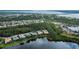 Community aerial view showcasing lush greenery, beautiful lakes, and diverse home styles at 14455 Silver Lakes Cir, Port Charlotte, FL 33953
