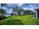 Picturesque backyard view with a peaceful lake and well-manicured lawn at 14455 Silver Lakes Cir, Port Charlotte, FL 33953