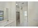 Bright bathroom featuring a white vanity and a shower with tiled walls at 14455 Silver Lakes Cir, Port Charlotte, FL 33953