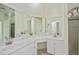 Bathroom featuring a double vanity, stone counters, and a large mirror at 14455 Silver Lakes Cir, Port Charlotte, FL 33953