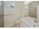 Bright bathroom with single sink, white countertops, framed mirror, and a glass-enclosed shower at 14455 Silver Lakes Cir, Port Charlotte, FL 33953