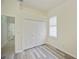 Bedroom with wood-look floors, white closet doors and a window with white shutters at 14455 Silver Lakes Cir, Port Charlotte, FL 33953